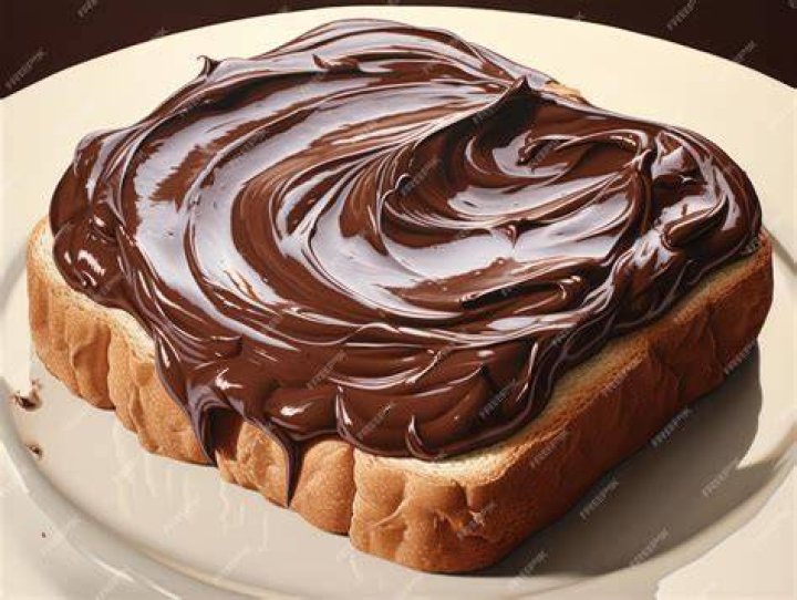 Bread topped with chocolate spread and fresh fruit.