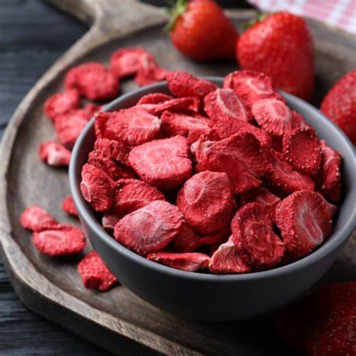 Freeze dried strawberries in a white bowl.
