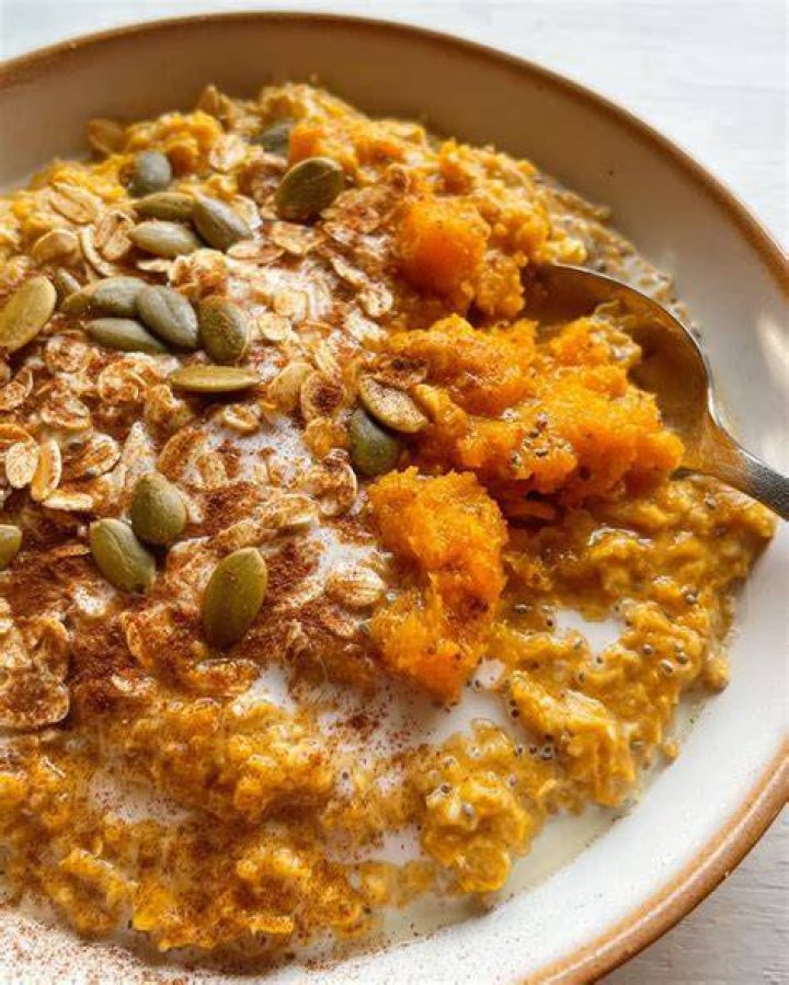 Pumpkin oatmeal in two white bowls.