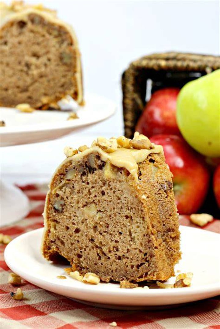 Slice of apple bundt cake on a white plate.