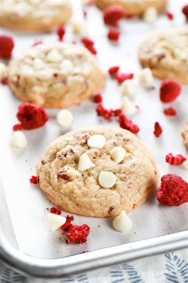 White chocolate raspberry cookie on a piece of parchment paper.